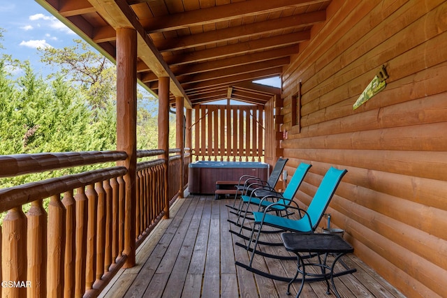 wooden terrace with a hot tub