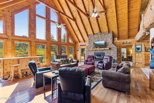 living room with beam ceiling, high vaulted ceiling, and wood ceiling