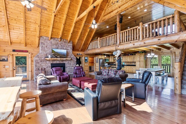 living room featuring high vaulted ceiling, wooden walls, beam ceiling, wood-type flooring, and wood ceiling