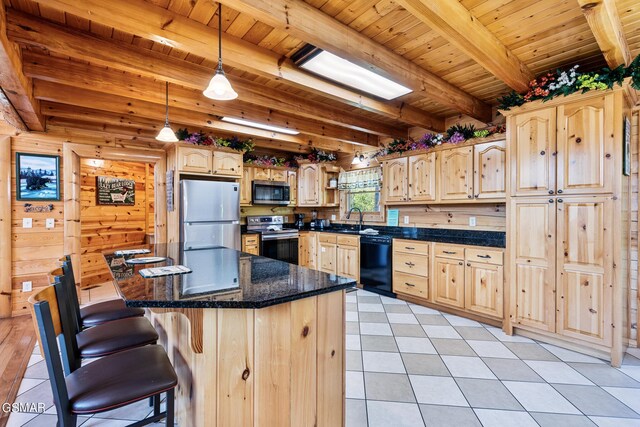 kitchen with beam ceiling, light brown cabinets, a kitchen island, and stainless steel appliances