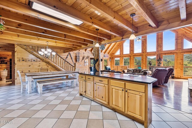 kitchen with light tile patterned floors, decorative light fixtures, beam ceiling, wood ceiling, and a chandelier