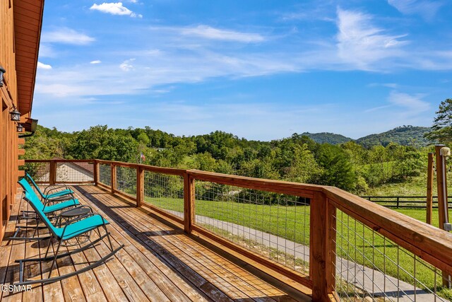 wooden deck featuring a yard