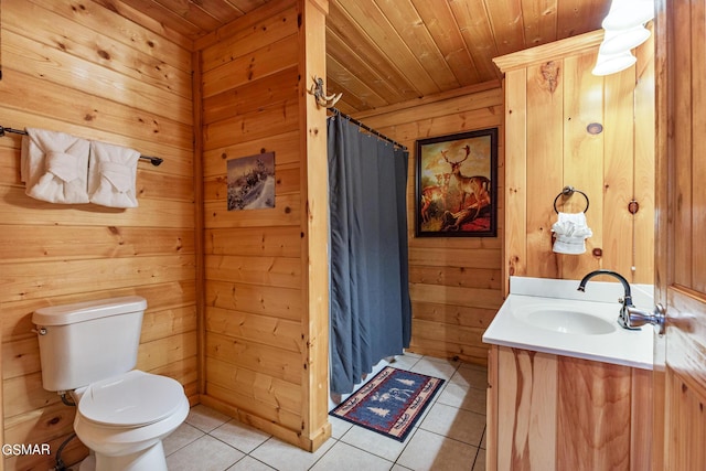 bathroom with vanity, wooden walls, wooden ceiling, tile patterned flooring, and toilet