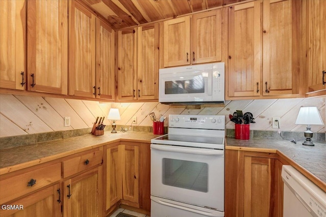 kitchen with tasteful backsplash, white appliances, and light countertops