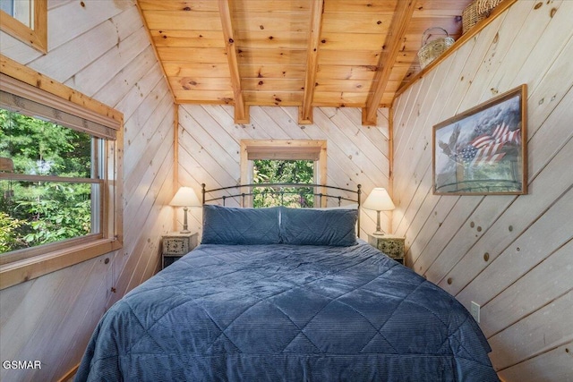 bedroom featuring beamed ceiling, multiple windows, and wooden walls