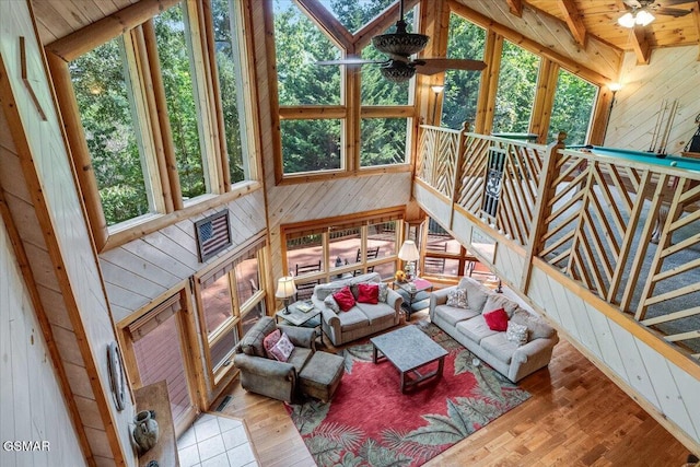 sunroom with beamed ceiling and ceiling fan