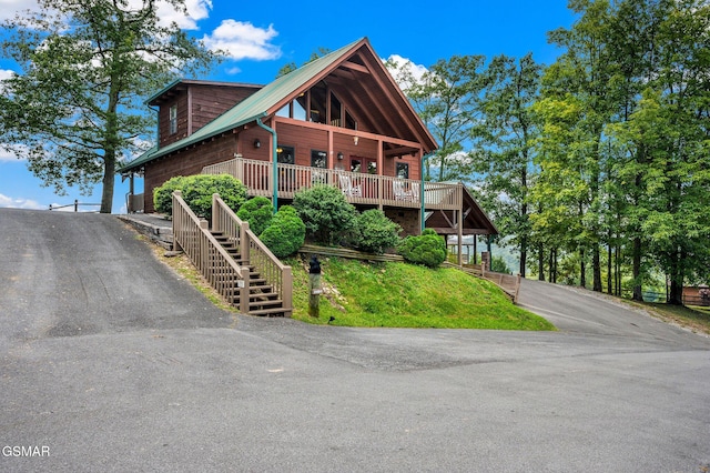 log home featuring a wooden deck