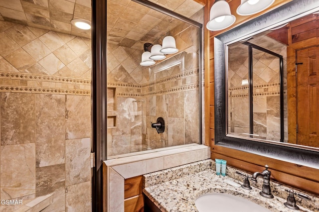 bathroom featuring vanity and a shower with shower door