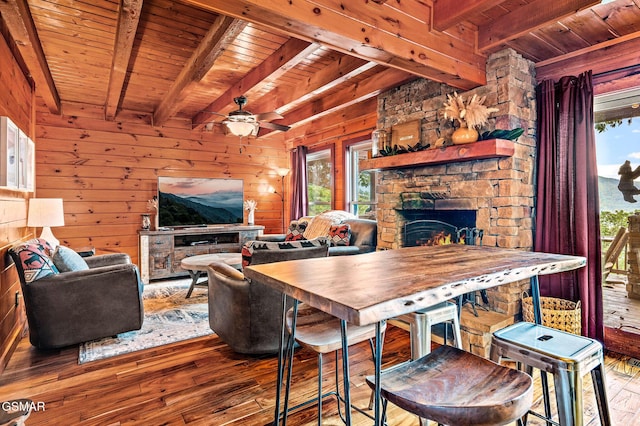 interior space featuring ceiling fan, plenty of natural light, and beamed ceiling