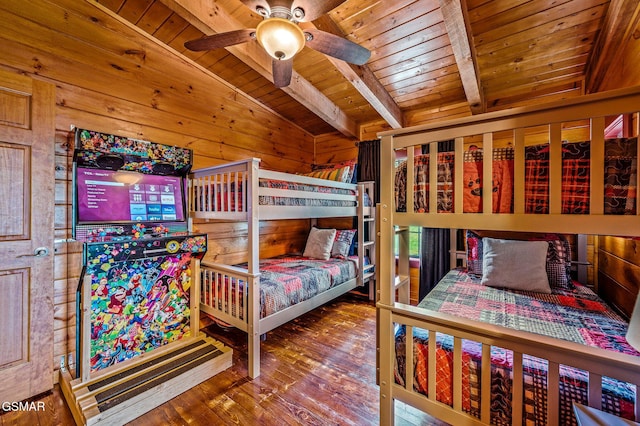 bedroom featuring wood ceiling, ceiling fan, hardwood / wood-style floors, vaulted ceiling with beams, and wood walls