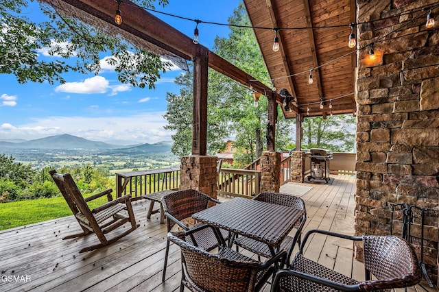 wooden terrace with area for grilling and a mountain view