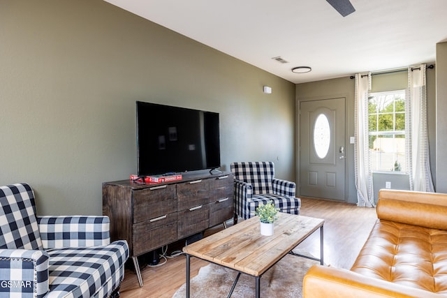 living area with visible vents and light wood-style flooring