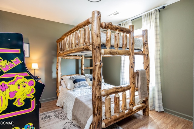 bedroom featuring baseboards and wood finished floors