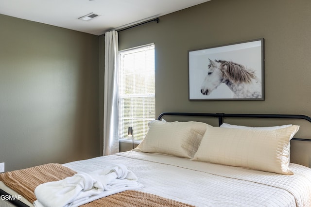 bedroom with multiple windows and visible vents