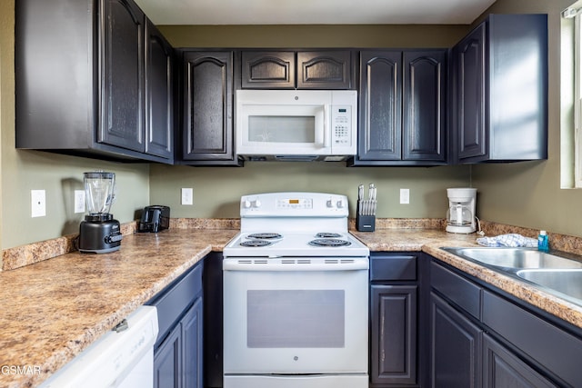 kitchen featuring a sink, white appliances, and light countertops