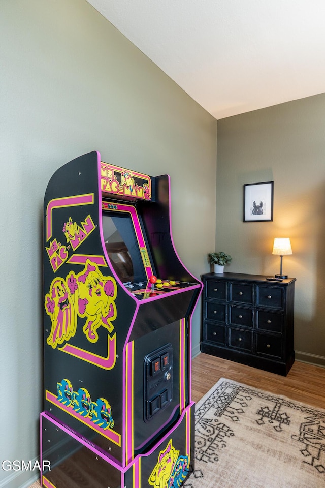 recreation room with wood finished floors and baseboards