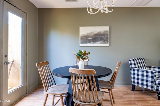 dining room featuring a wealth of natural light, visible vents, and light wood-style floors