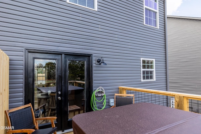 wooden deck featuring outdoor dining area and french doors