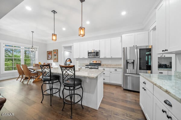 kitchen featuring recessed lighting, white cabinets, and stainless steel appliances