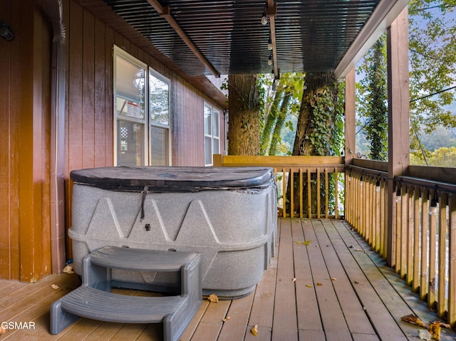 wooden deck with a hot tub