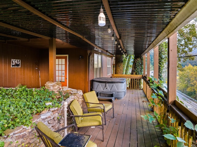 wooden deck with a hot tub