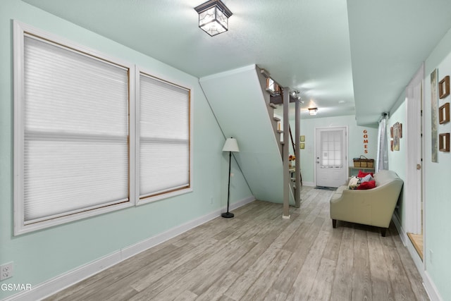 interior space featuring vaulted ceiling and light wood-type flooring