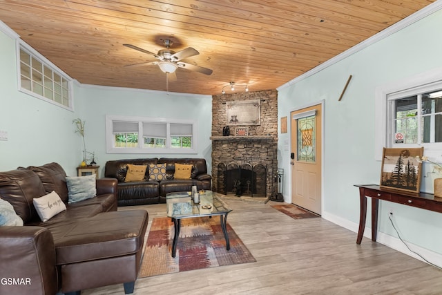 living room featuring light wood-type flooring, ornamental molding, ceiling fan, wooden ceiling, and a fireplace