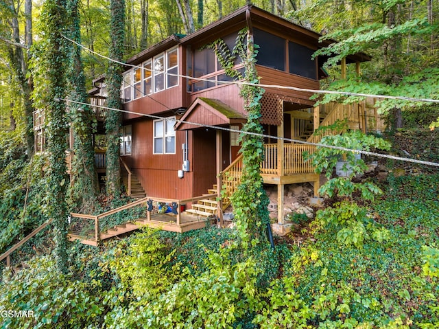 back of property with a sunroom