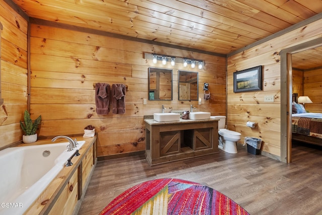 bathroom with toilet, wood ceiling, wood finished floors, connected bathroom, and a garden tub