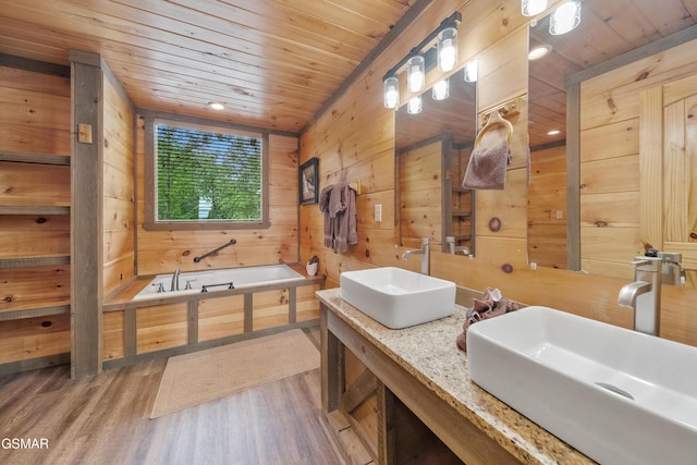 bathroom with a sink, wood walls, wooden ceiling, and wood finished floors