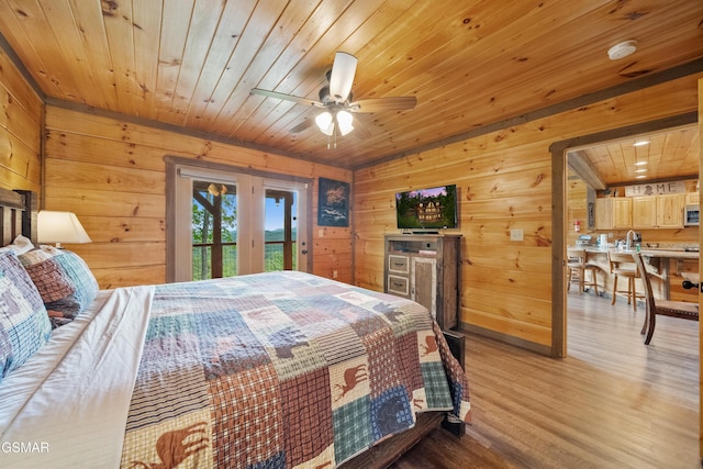 bedroom with wooden walls, access to outside, light wood-style flooring, and wood ceiling