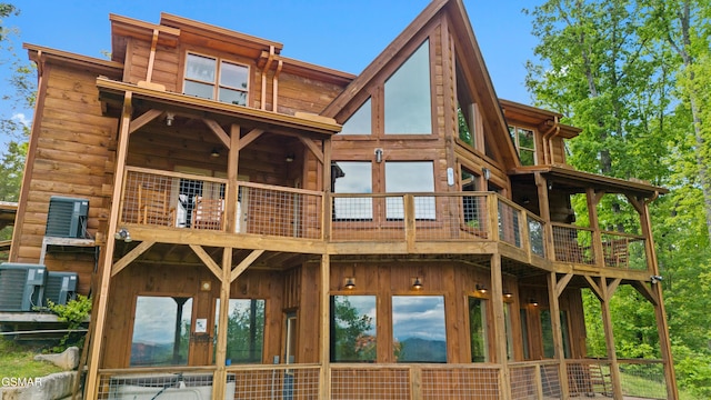 back of house featuring central AC and a balcony