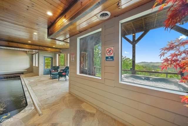 view of home's exterior with a mountain view and a patio area