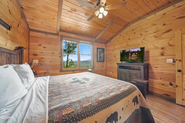 bedroom featuring lofted ceiling, light wood-style floors, wood walls, and wood ceiling