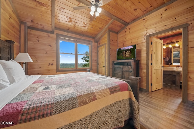 bedroom featuring lofted ceiling with beams, wooden walls, wooden ceiling, and wood finished floors