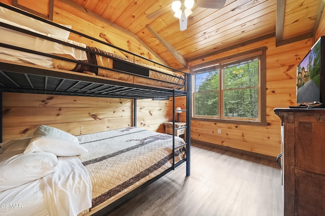 bedroom with wood ceiling, wooden walls, wood finished floors, and lofted ceiling