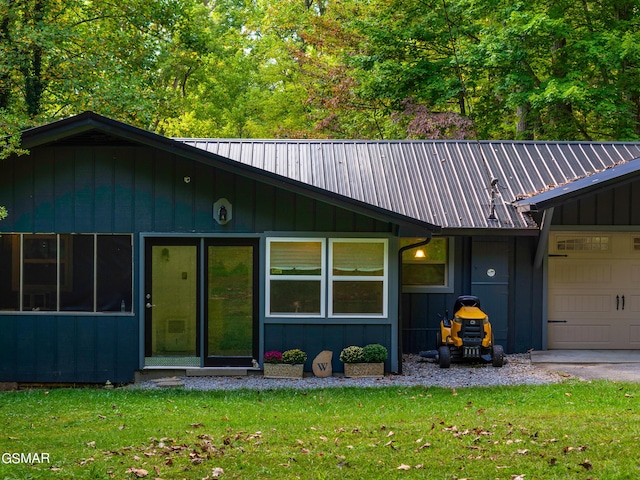 view of front of property with a garage and a front lawn