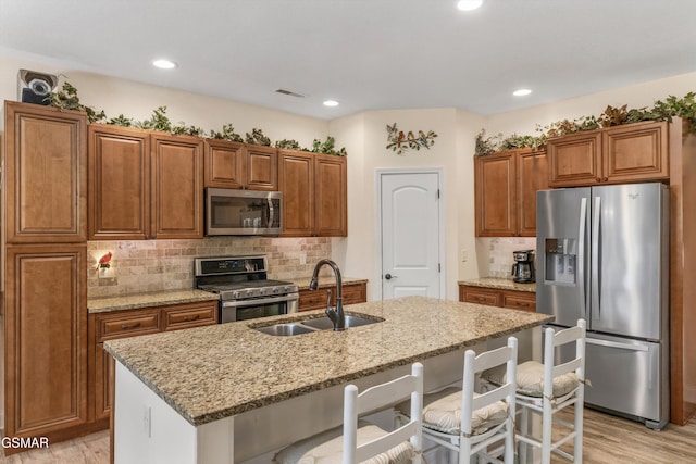 2159 Frewin Ct, Sevierville, TN 37876 - kitchen featuring appliances with stainless steel finishes, light wood-style floors, brown cabinets, and recessed lighting