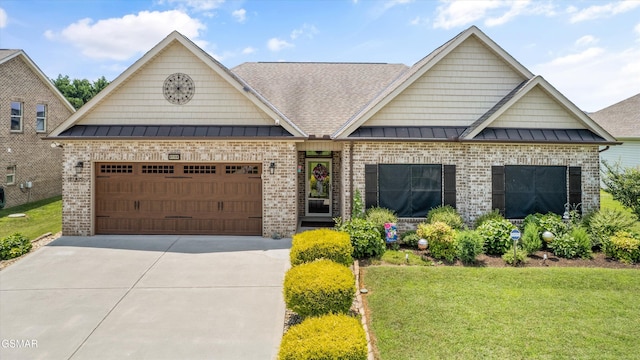 2159 Frewin Ct, Sevierville, TN 37876 - craftsman-style house featuring brick siding, a standing seam roof, a front yard, and driveway