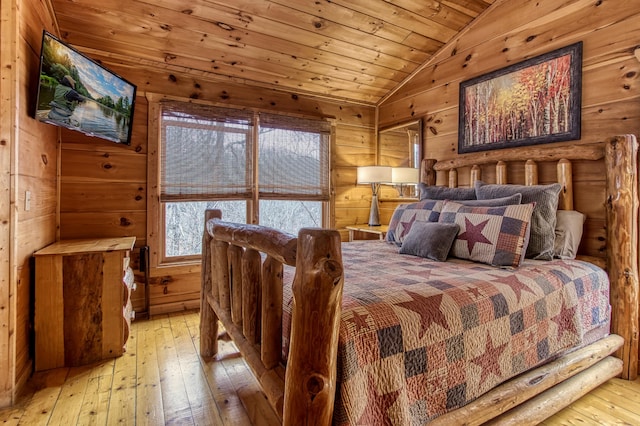 bedroom with lofted ceiling, light wood-type flooring, wood ceiling, and multiple windows