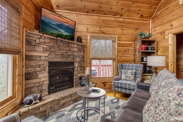 unfurnished living room featuring plenty of natural light, a fireplace, wooden ceiling, and vaulted ceiling