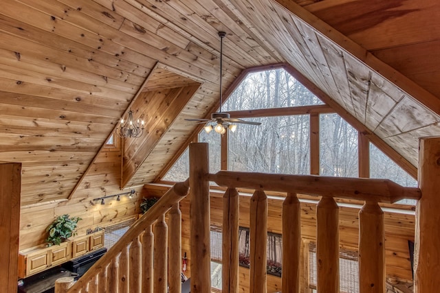 interior space with wooden walls, wood ceiling, and ceiling fan with notable chandelier