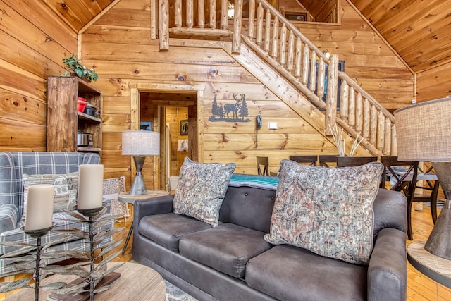 living room with lofted ceiling, wooden ceiling, and wood walls