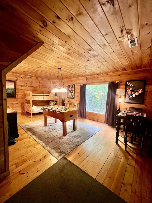 game room featuring hardwood / wood-style floors, wooden walls, and wooden ceiling