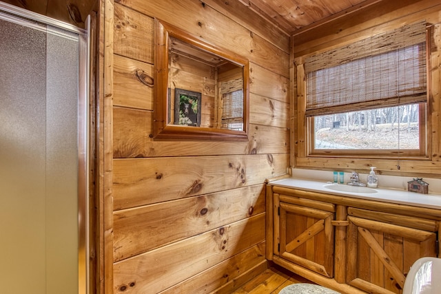 bathroom with wood walls, vanity, and wood ceiling