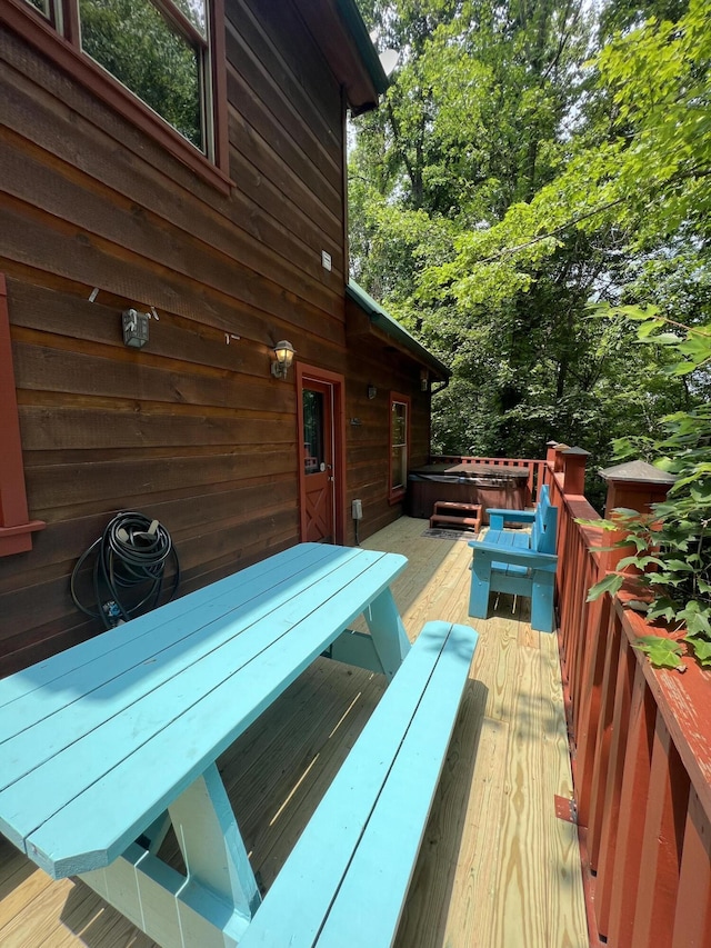 wooden deck with a hot tub