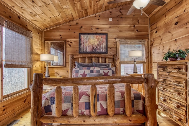 bedroom with wooden ceiling, wooden walls, and vaulted ceiling