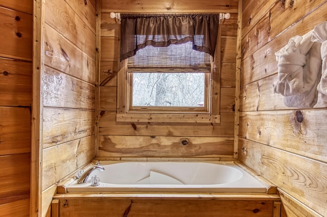 bathroom with wood walls and a washtub