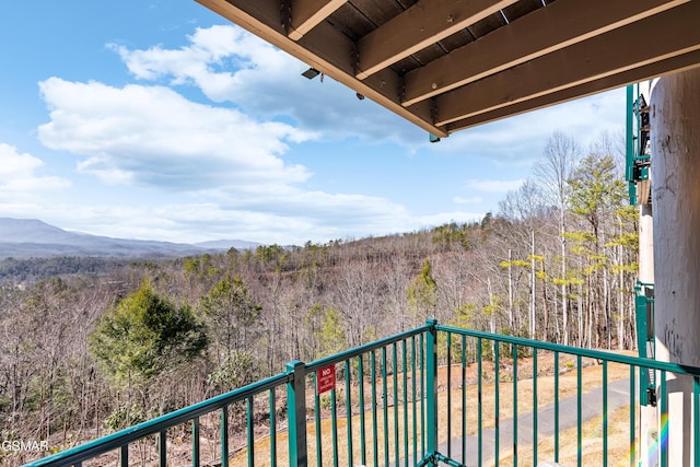 balcony featuring a view of trees