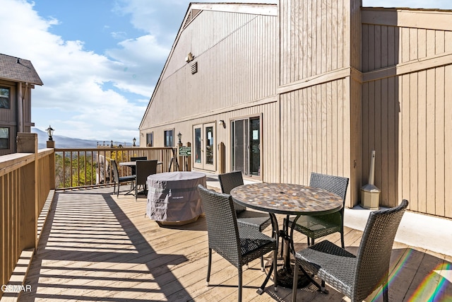 wooden terrace with outdoor dining area